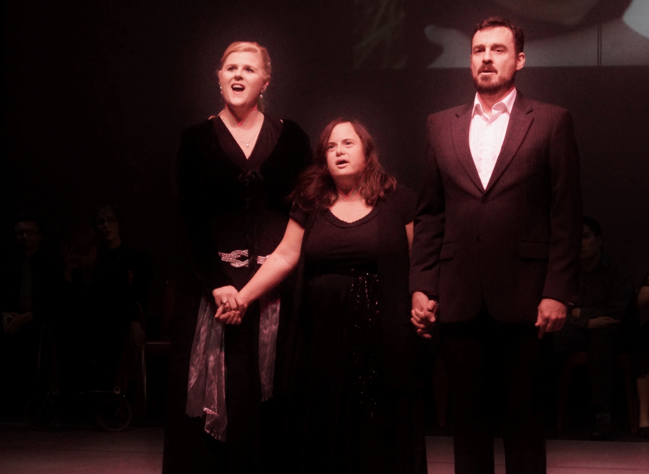 Three performers on stage